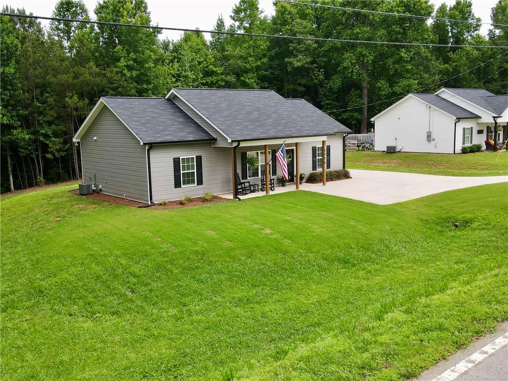 1776 Pleasant Grove Road Temple, GA 30179 - Photo 2 of 45 a aerial view of a house next to a big yard and large trees