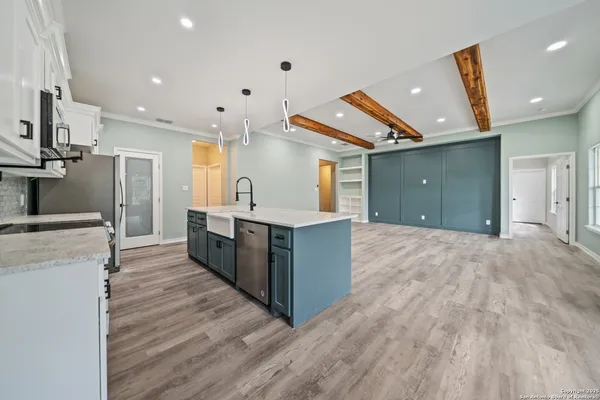 a large room with a large window and wooden floor