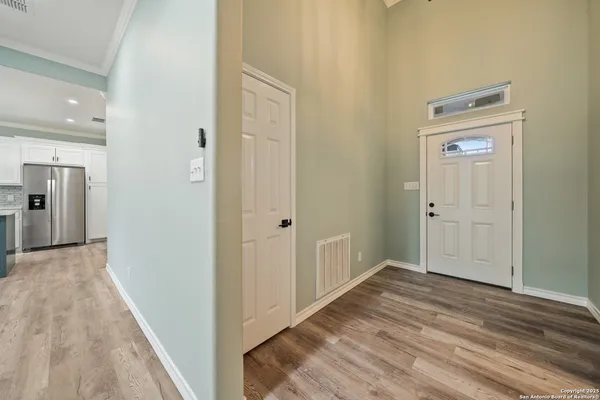 a view of a hallway with wooden floor