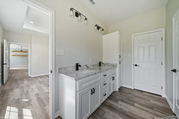 a kitchen with a refrigerator and a sink