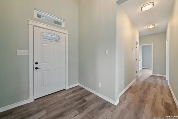a view of a hallway with wooden floor