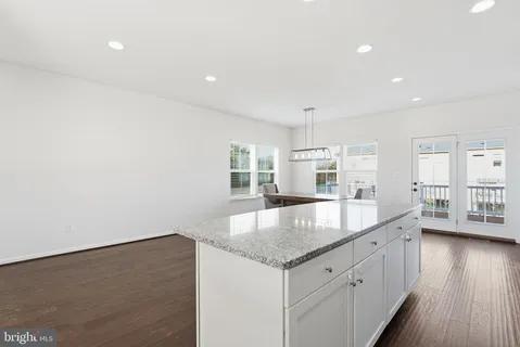 a large kitchen with granite countertop a large counter top and sink