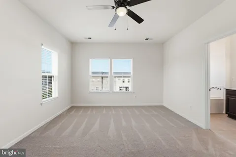 a bathroom with a tub a sink double vanity and a mirror