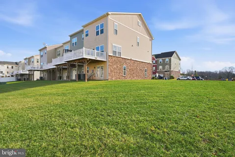 a large building with a big yard and large trees