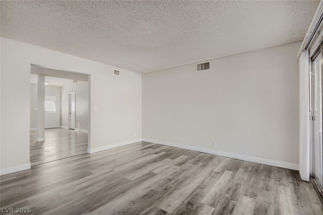 2343 Valleywood Road Henderson, NV 89014 - Photo 20 of 29 The generously sized living area boasts contemporary wood flooring and abundant light from sliding glass doors.