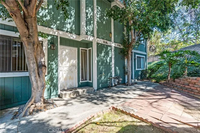 a view of a house with a tree in front
