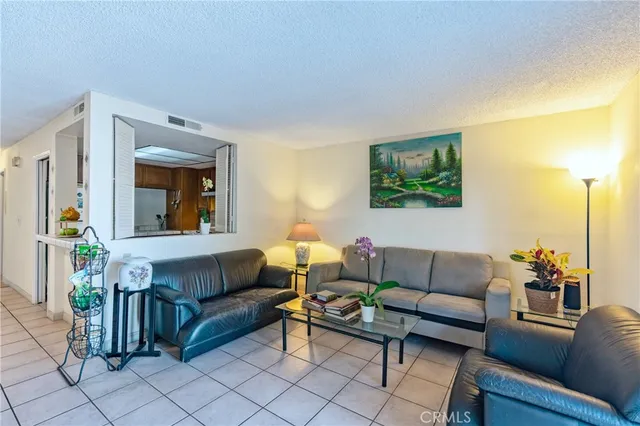 a living room with furniture a flat screen tv and next to a window