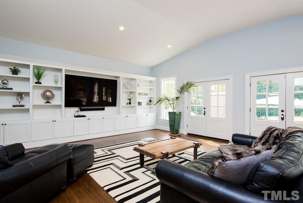 2611 Churchill Road Raleigh, NC 27608 - Photo 14 of 25 a living room with furniture and a flat screen tv