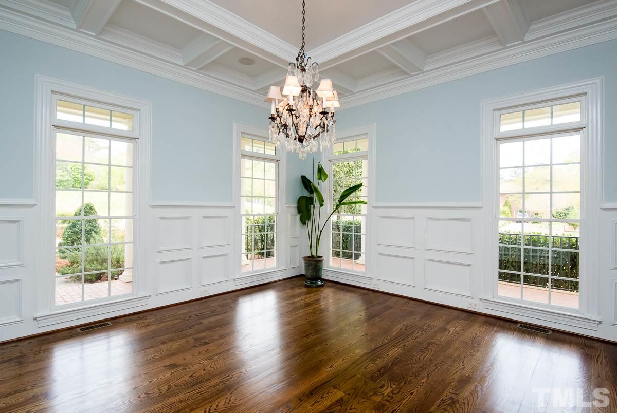 2611 Churchill Road Raleigh, NC 27608 - Photo 8 of 25 a view of an empty room with wooden floor and a window