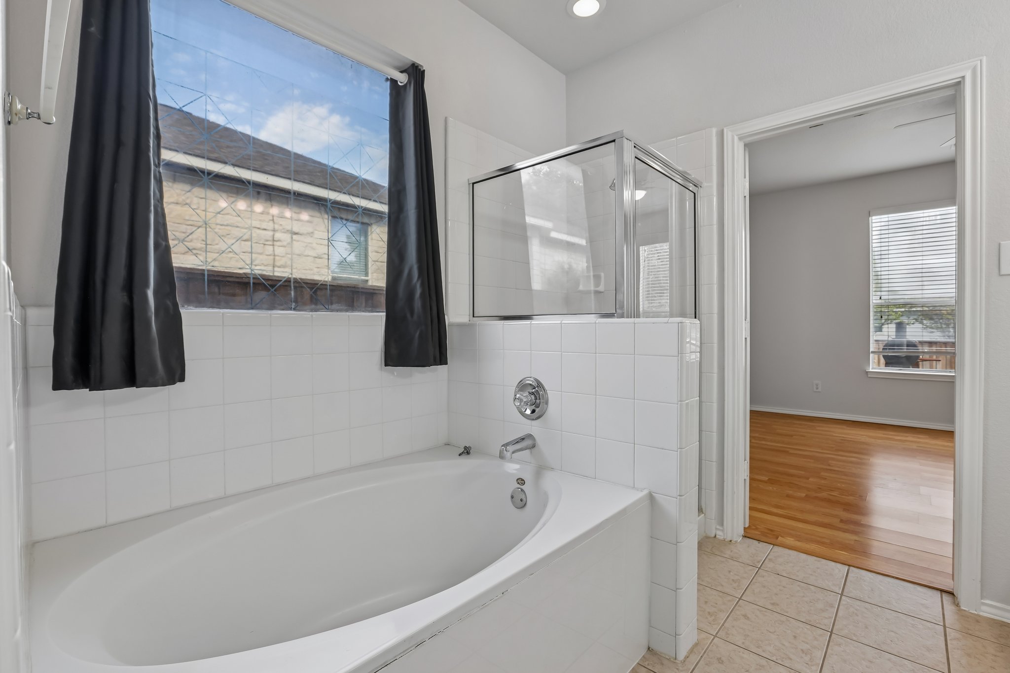 1721 Long Rifle Drive Austin, TX 78754 - Photo 15 of 38 A spacious bathroom offers a relaxing soaking tub and convenient adjacent shower.