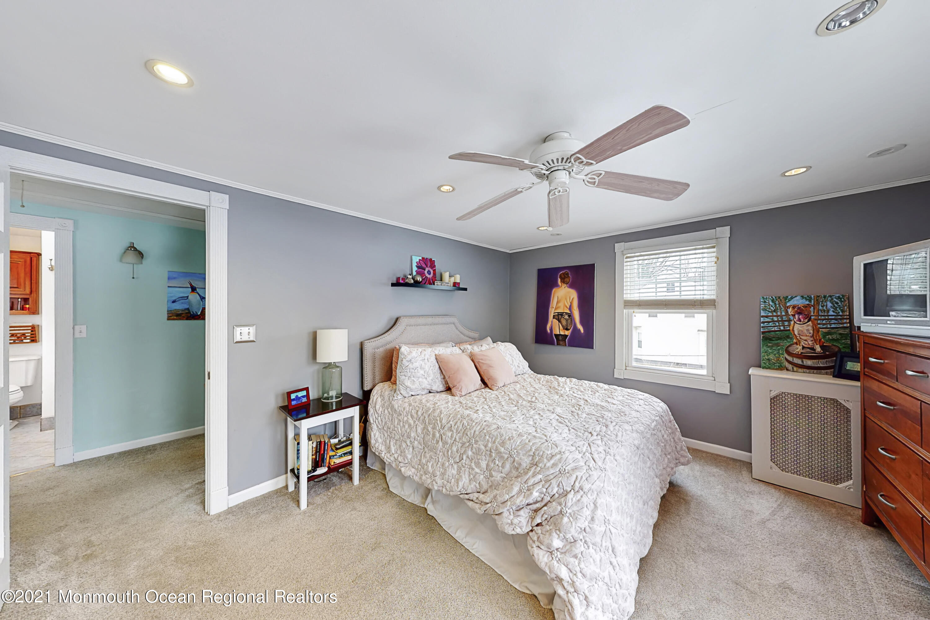 104 Bank Street Red Bank, NJ 07701 - Photo 14 of 33 a bedroom with a bed and a chandelier