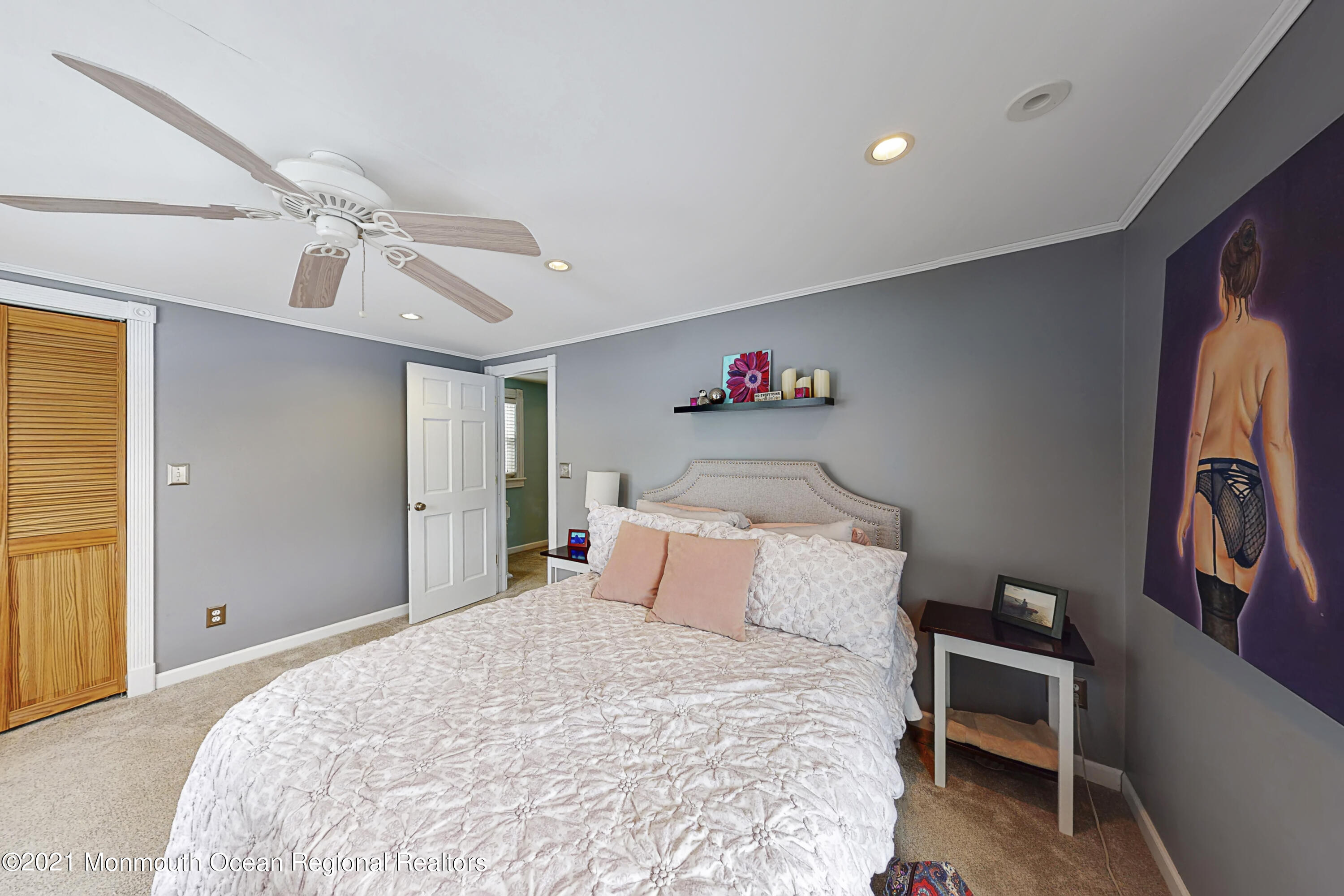 104 Bank Street Red Bank, NJ 07701 - Photo 16 of 33 a bedroom with a bed and a chandelier