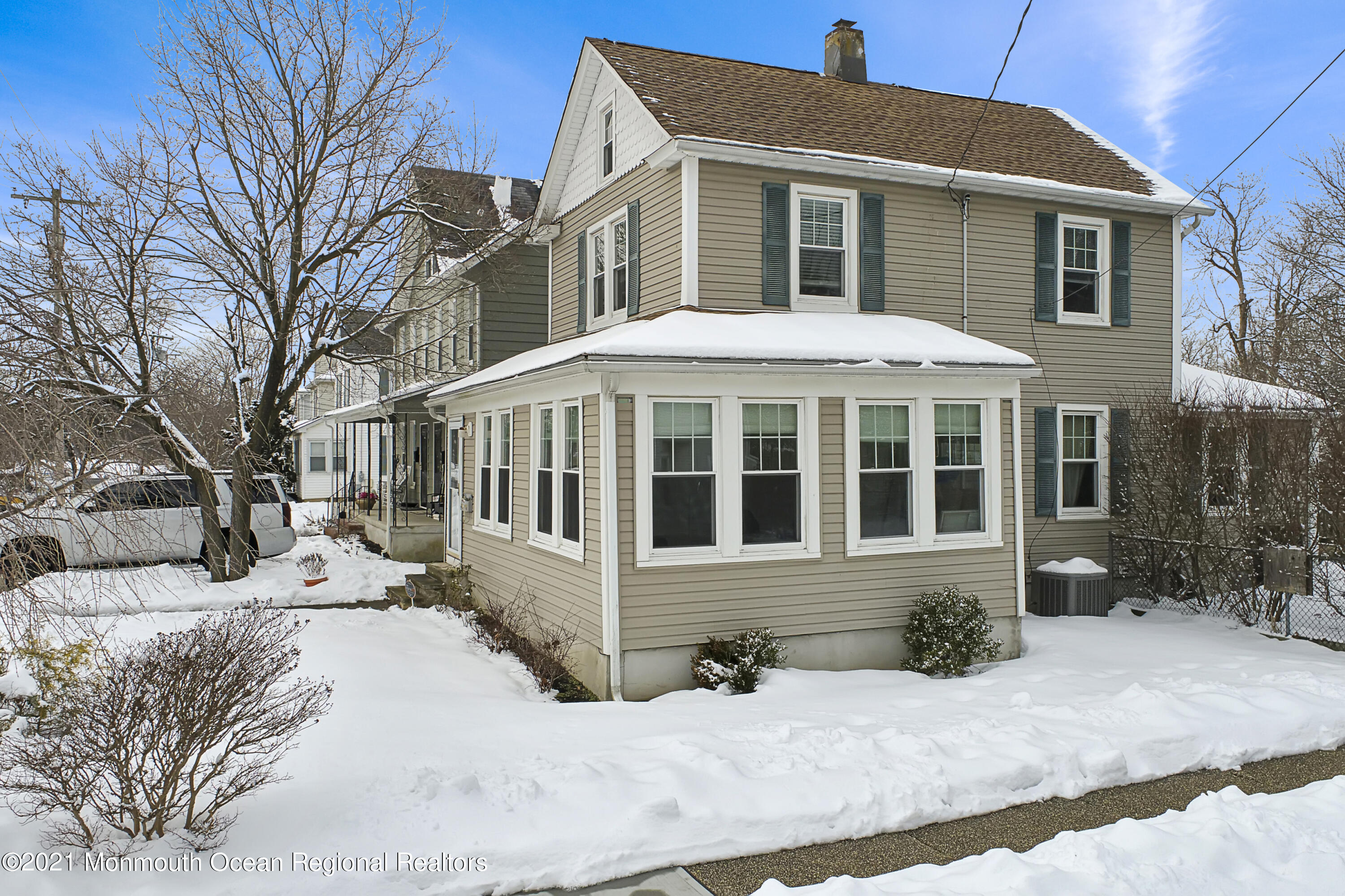 104 Bank Street Red Bank, NJ 07701 - Photo 22 of 33 a view of a white house with a yard covered in snow