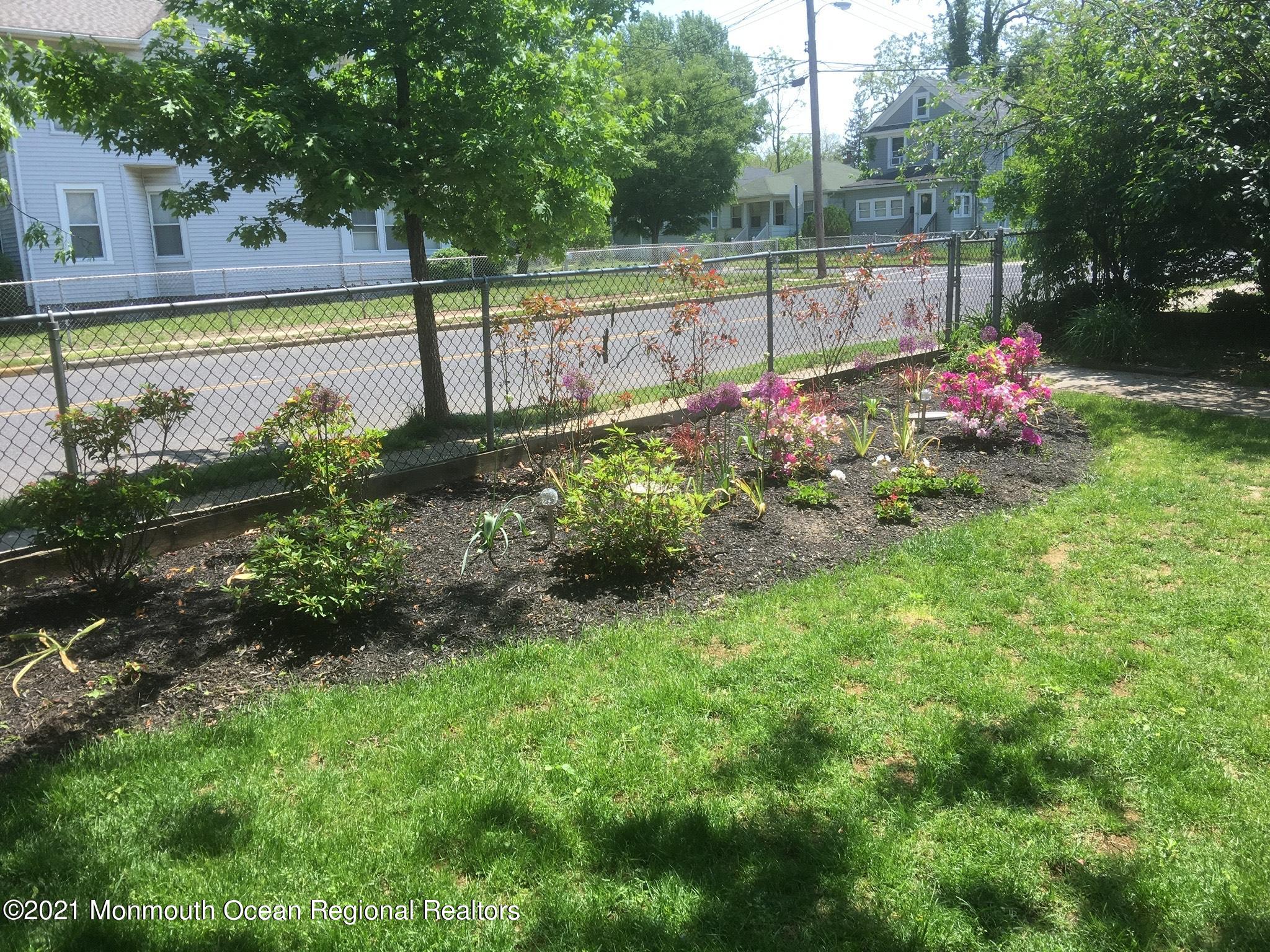 104 Bank Street Red Bank, NJ 07701 - Photo 25 of 33 a view of a garden with a bench in the background