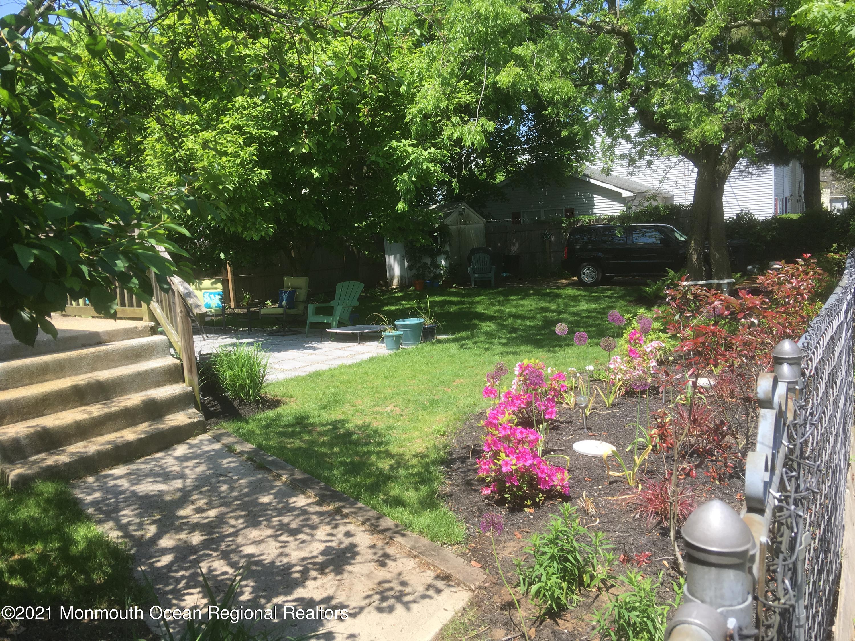 104 Bank Street Red Bank, NJ 07701 - Photo 27 of 33 a backyard of a house with yard and outdoor seating