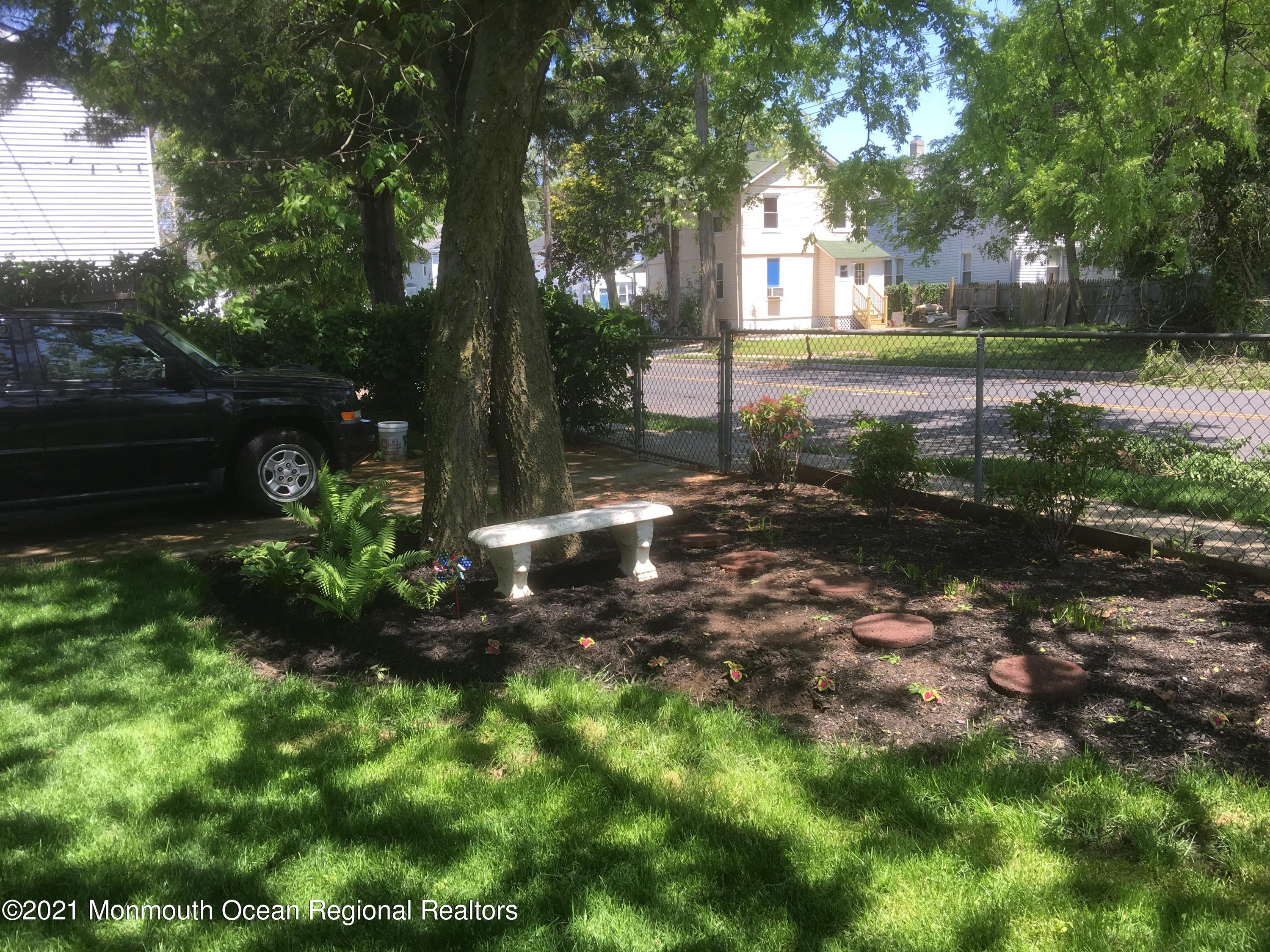 104 Bank Street Red Bank, NJ 07701 - Photo 30 of 33 a view of a yard with plants and large trees