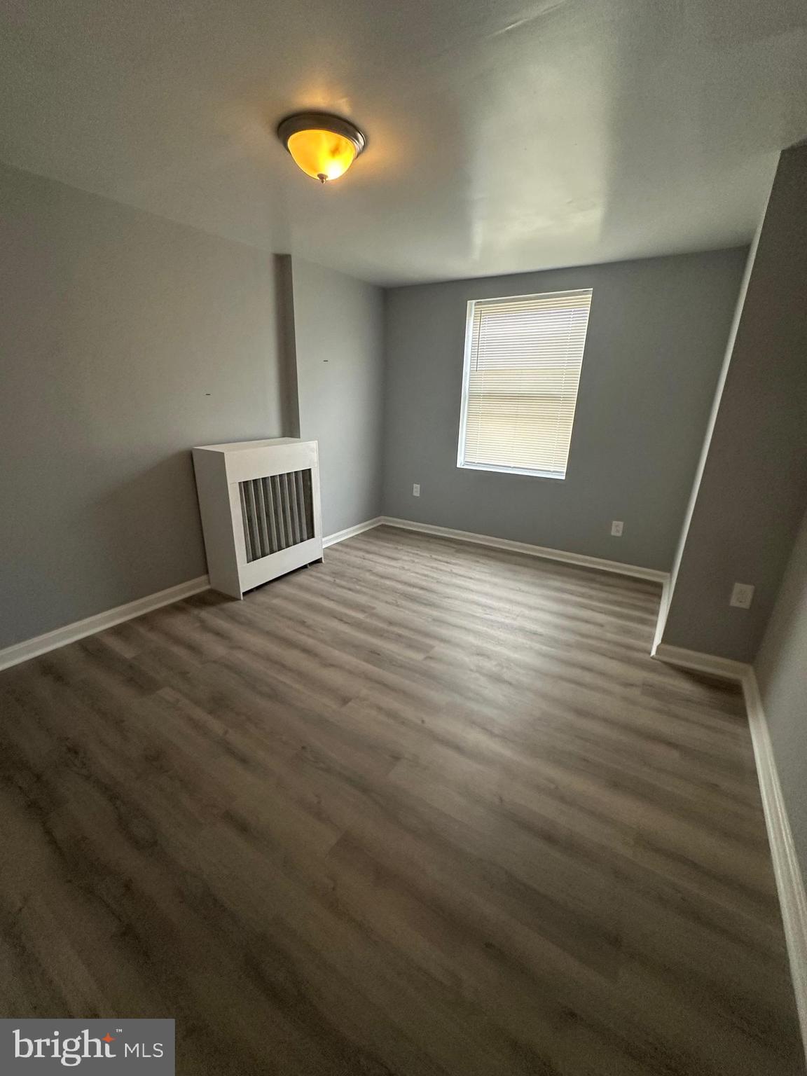 5935 Agusta Street Philadelphia, PA 19149 - Photo 7 of 13 a view of an empty room with window and wooden floor