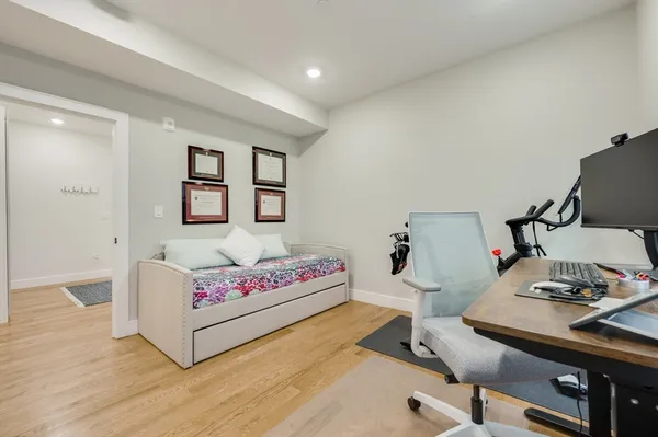 a bed room with a bed television and a large window