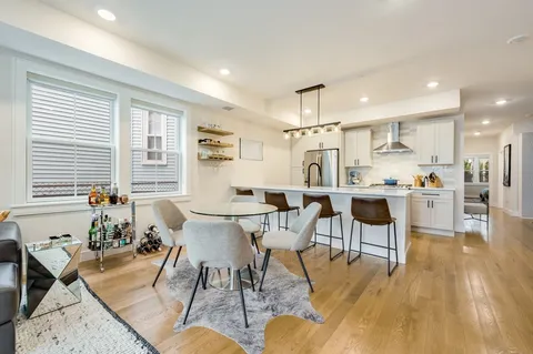 a view of a dining room with furniture and wooden floor