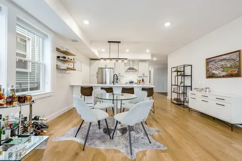 a view of a dining room with furniture and a window