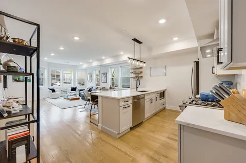 a large kitchen with a large counter top appliances and cabinets
