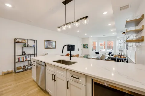 a view of a kitchen counter space a sink and appliances