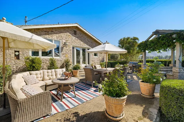 a dining room with furniture a rug and a chandelier