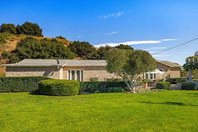 a living room with furniture a fireplace and a chandelier