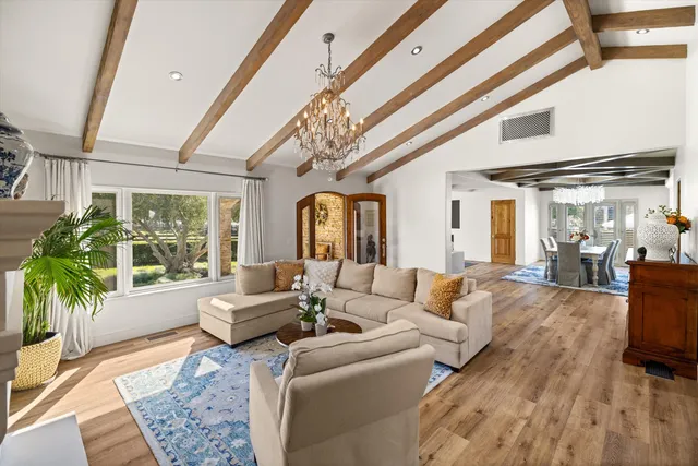 a living room with fireplace furniture and a large window