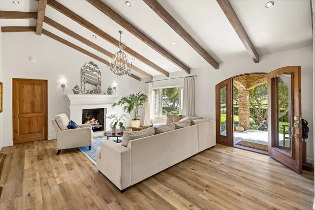 a view of a dining room with furniture wooden floor and chandelier