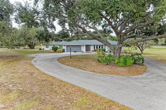 a kitchen with stainless steel appliances kitchen island granite countertop a refrigerator and a stove top oven