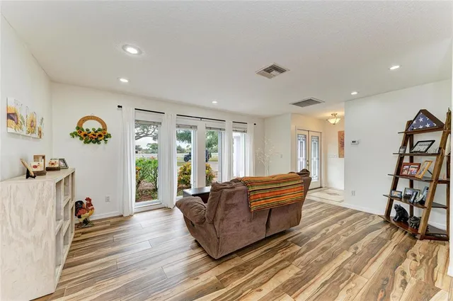 a house view with swimming pool and trees in front of it