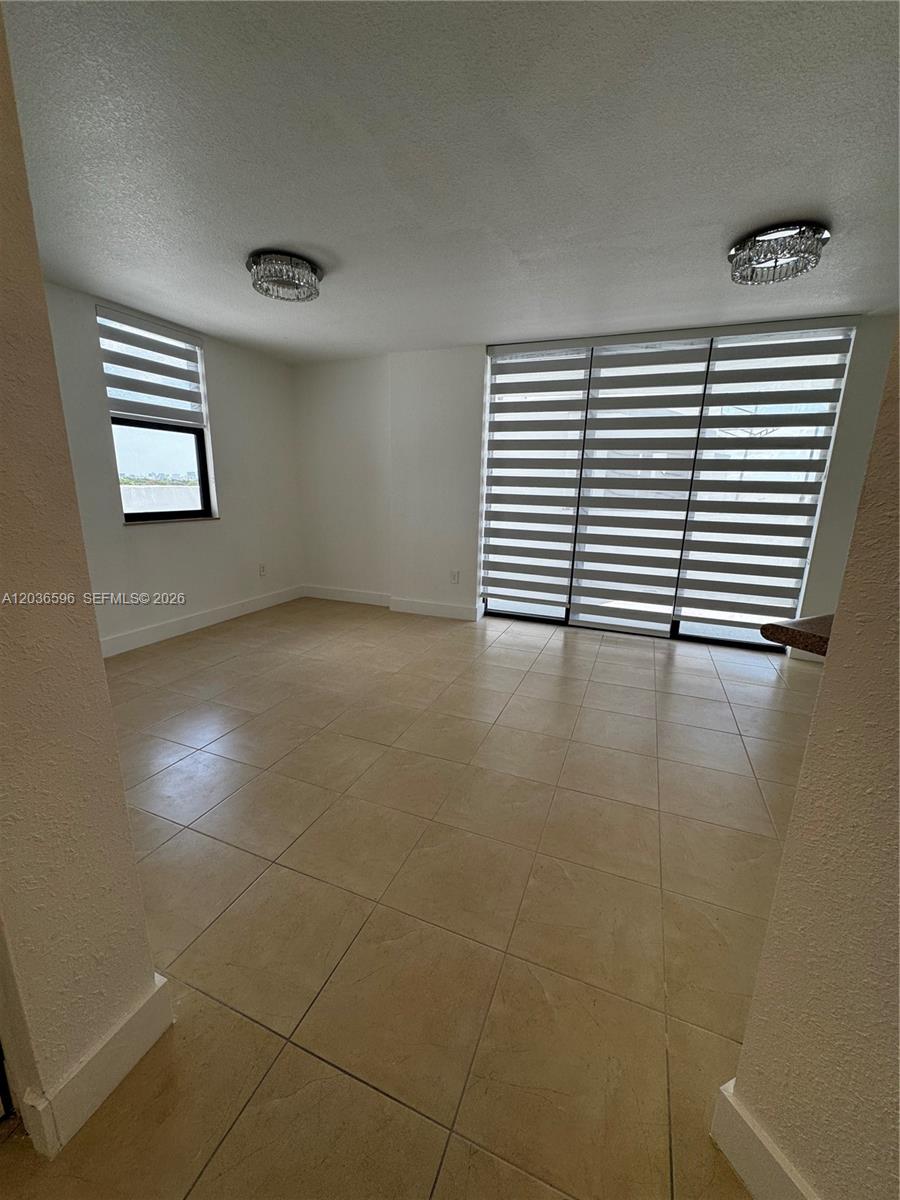 2301 Southwest 27th Avenue, Unit 503 Miami, FL 33145 - Photo 4 of 24 a view of an empty room with a window