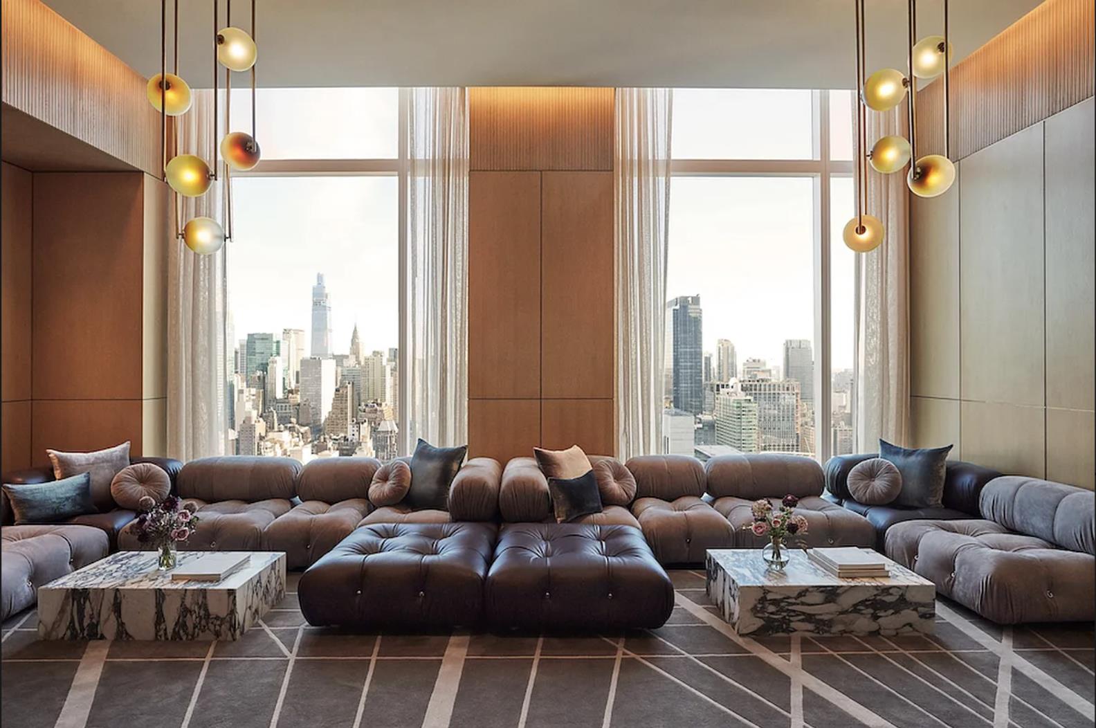 455 10th Avenue, Unit 33L Manhattan, NY 10018 - Photo 16 of 18 a living room with furniture and a large window