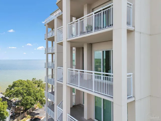 a view of a city from a balcony with furniture