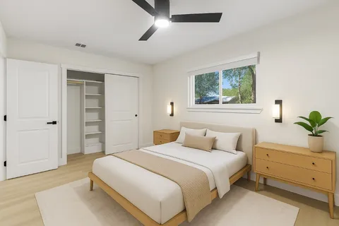 a bedroom with a bed and a potted plant