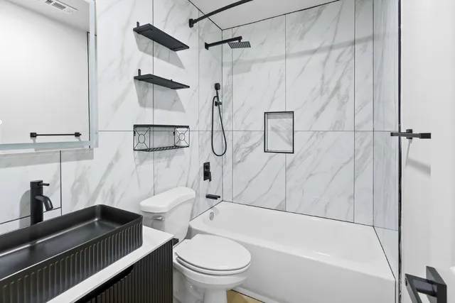 a bathroom with a sink toilet and shower