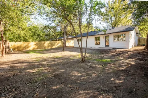 a backyard of a house with a tree
