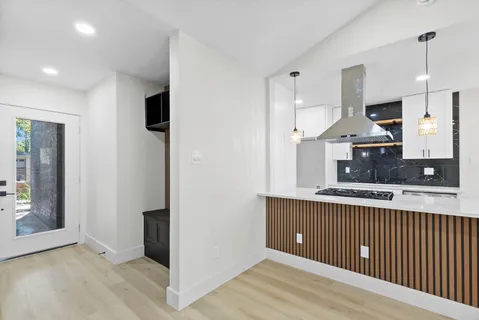 a kitchen with stainless steel appliances granite countertop a refrigerator and a sink