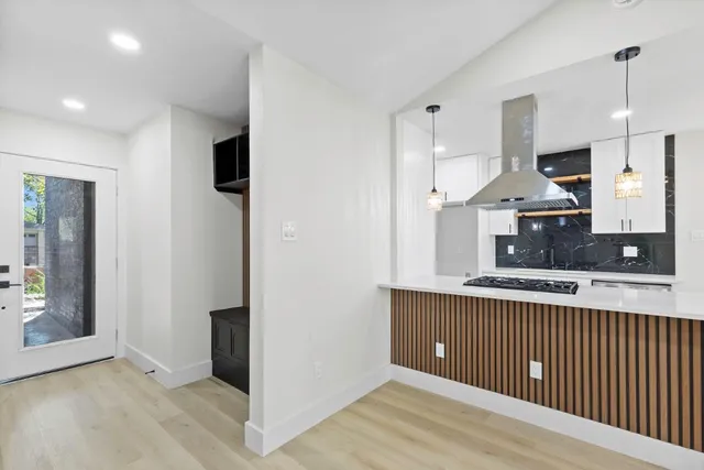 a kitchen with stainless steel appliances granite countertop a refrigerator and a sink