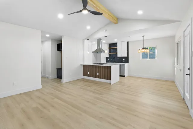 an empty room with kitchen and a sink