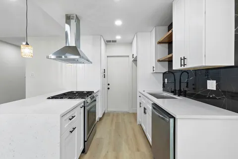 a kitchen with a stove and a sink