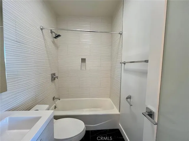 a bathroom with a toilet bathtub and shower