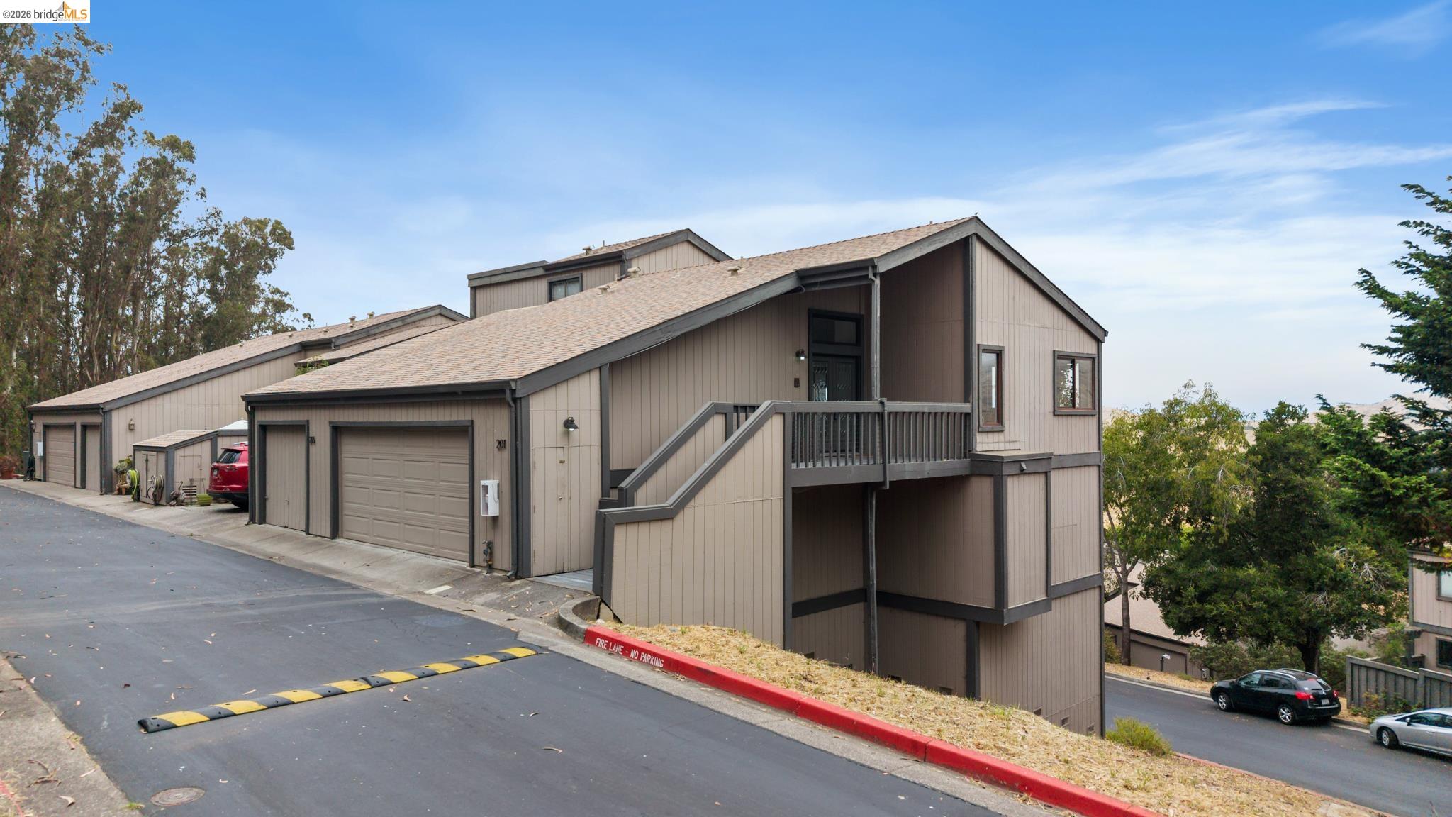 201 Vista Heights Road El Cerrito, CA 94530 - Photo 23 of 32 Multi-level building exterior featuring a neutral tone facade, dark trim, and a prominent balcony entry