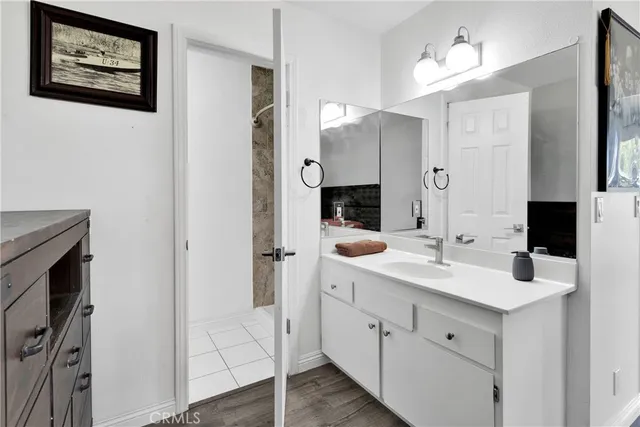 a bathroom with a double vanity sink and mirror