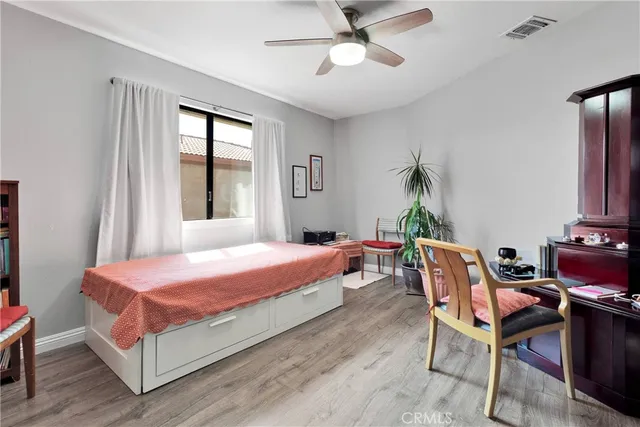 a bedroom with a bed and a chair