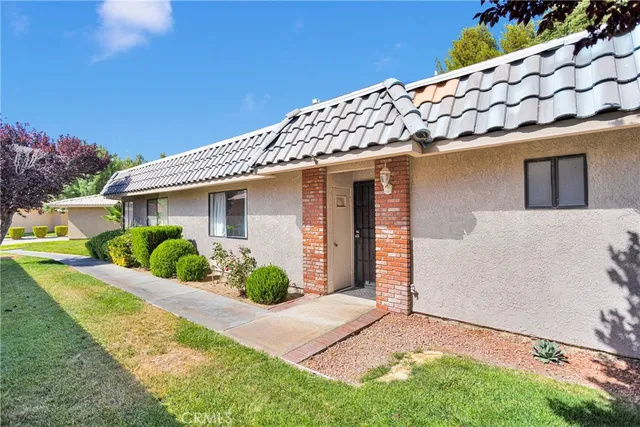 a view of a house with a yard and plants