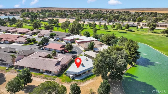an aerial view of a house with a yard and pool