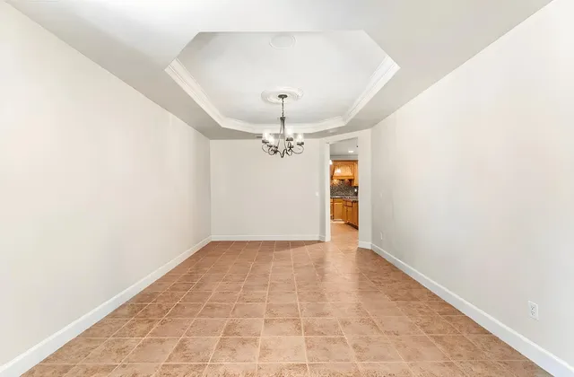 a view of an empty room with a window and a fireplace