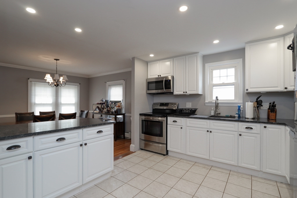31 Thornton Street Springfield, MA 01104 - Photo 11 of 32 a kitchen with white cabinets sink and appliances